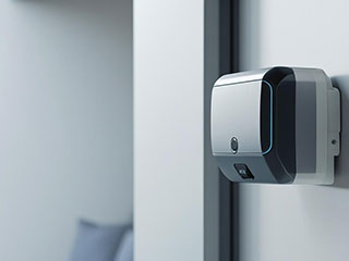 Garage Door Opener Installation in Forest Hills, NY A technician installing a modern garage door opener in a Forest Hills, NY home, using precision tools and safety equipment.