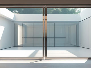 Contemporary Glass Garage Door Installed in Forest Hills, NY Sleek modern glass garage door with aluminum framing, letting in natural light to a stylish Forest Hills, NY home.