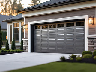 Professional Overhead Garage Door Service in Forest Hills, NY Technician servicing a modern overhead garage door on a suburban Forest Hills, NY property, ensuring safe and reliable door operation.